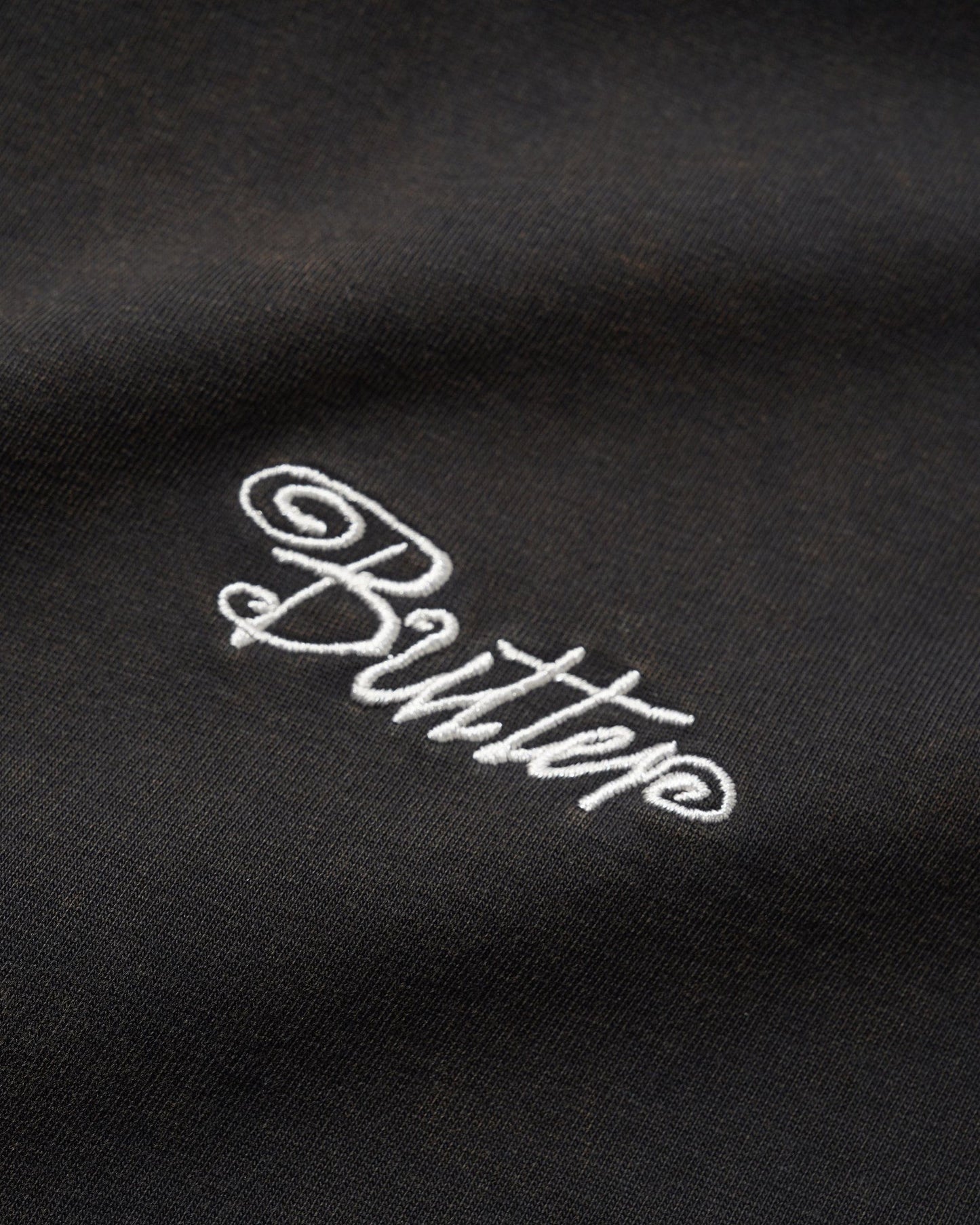 Butter Jive Overlock Stitch Tee: Distressed Black