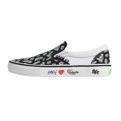 A black slip-on platform sneaker with a white bandana print, featuring white side patches with red and blue graphics, on a solid white background.