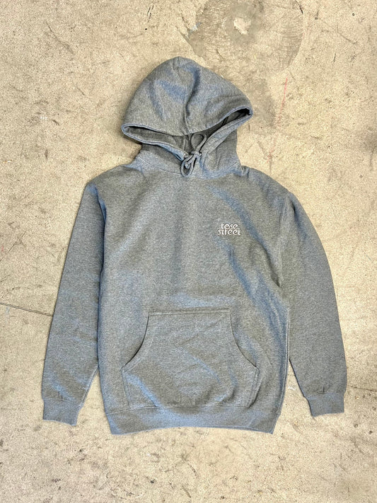 Gray hoodie with a brand logo on a textured beige surface
