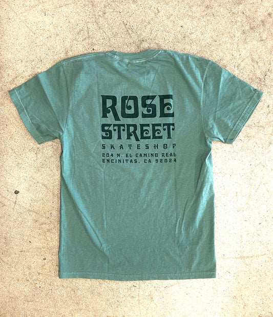 Green t-shirt with 'Rose Street Skate Shop' text on a beige background