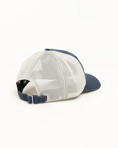 A rear three-quarter view of a trucker-style baseball cap with a white mesh back and navy blue front panel, visor, and adjustable strap, set against a plain white background.