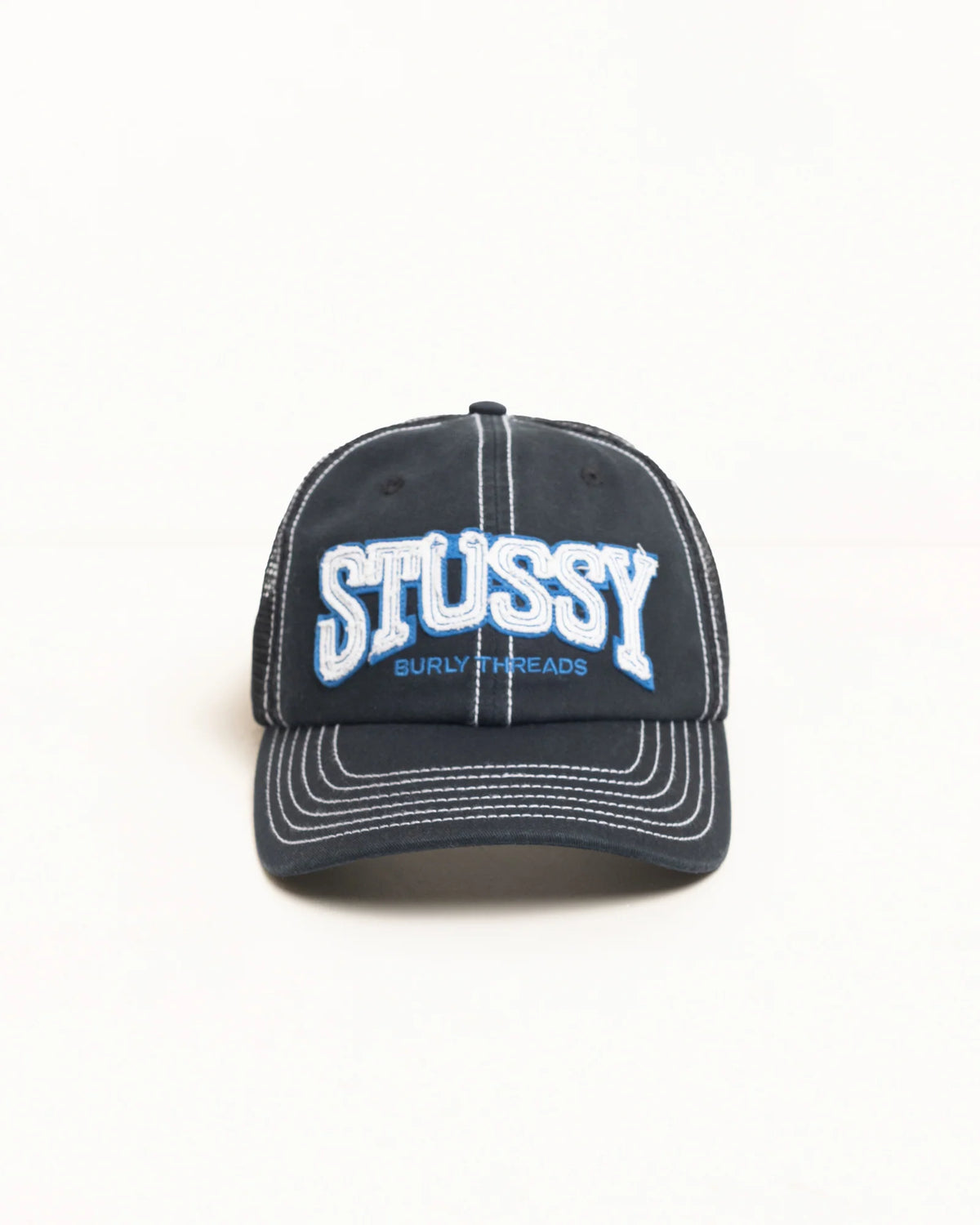 Black cap with 'Stussy' logo on a white background