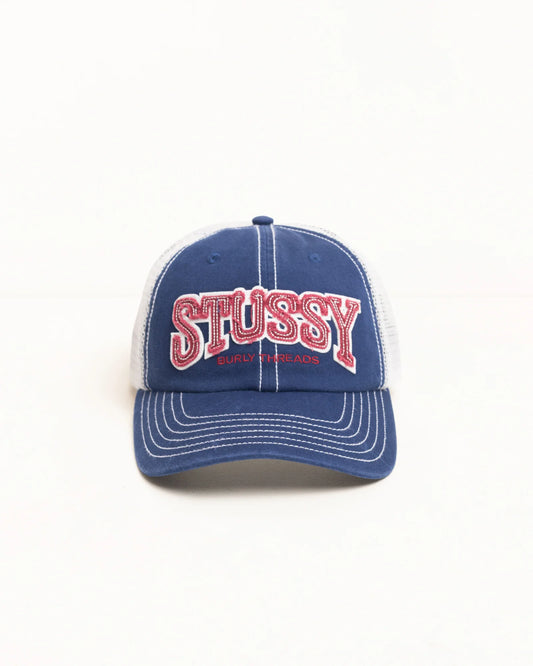 Blue and white cap with 'Stussy' logo on a white background