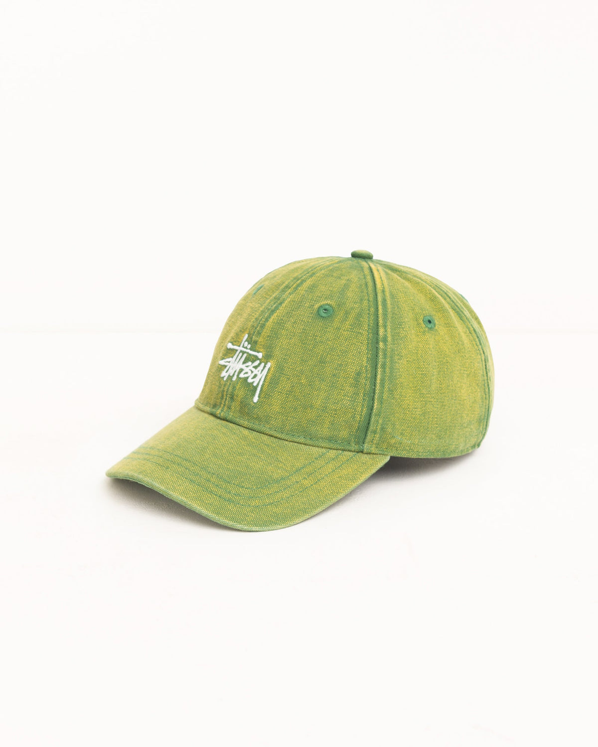 A Stussy baseball cap in a washed olive green color with the brand's signature script logo embroidered in white on the front, set against a plain white background.