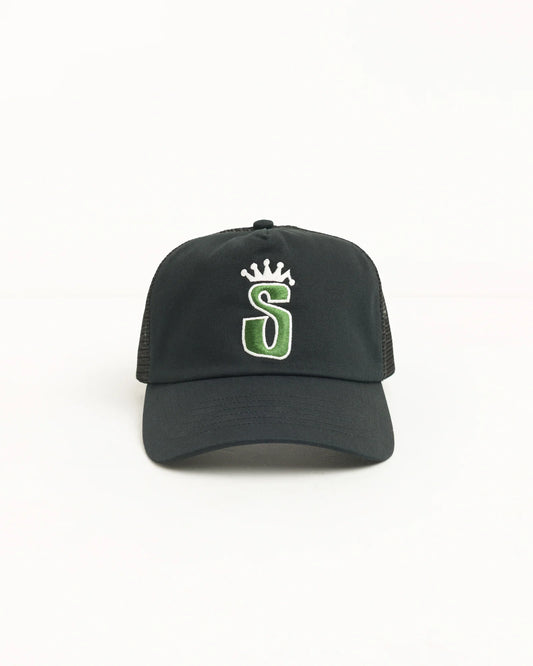 A black trucker-style baseball cap with a green and white embroidered letter 'S' under a small white crown on the front, shown against a plain white background.