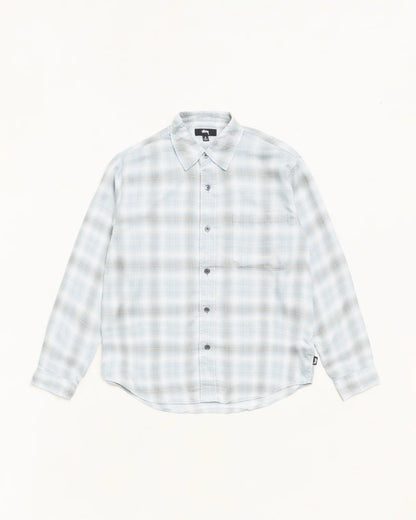A long-sleeve button-up shirt with a light gray and white plaid pattern, laid flat against a solid off-white background.