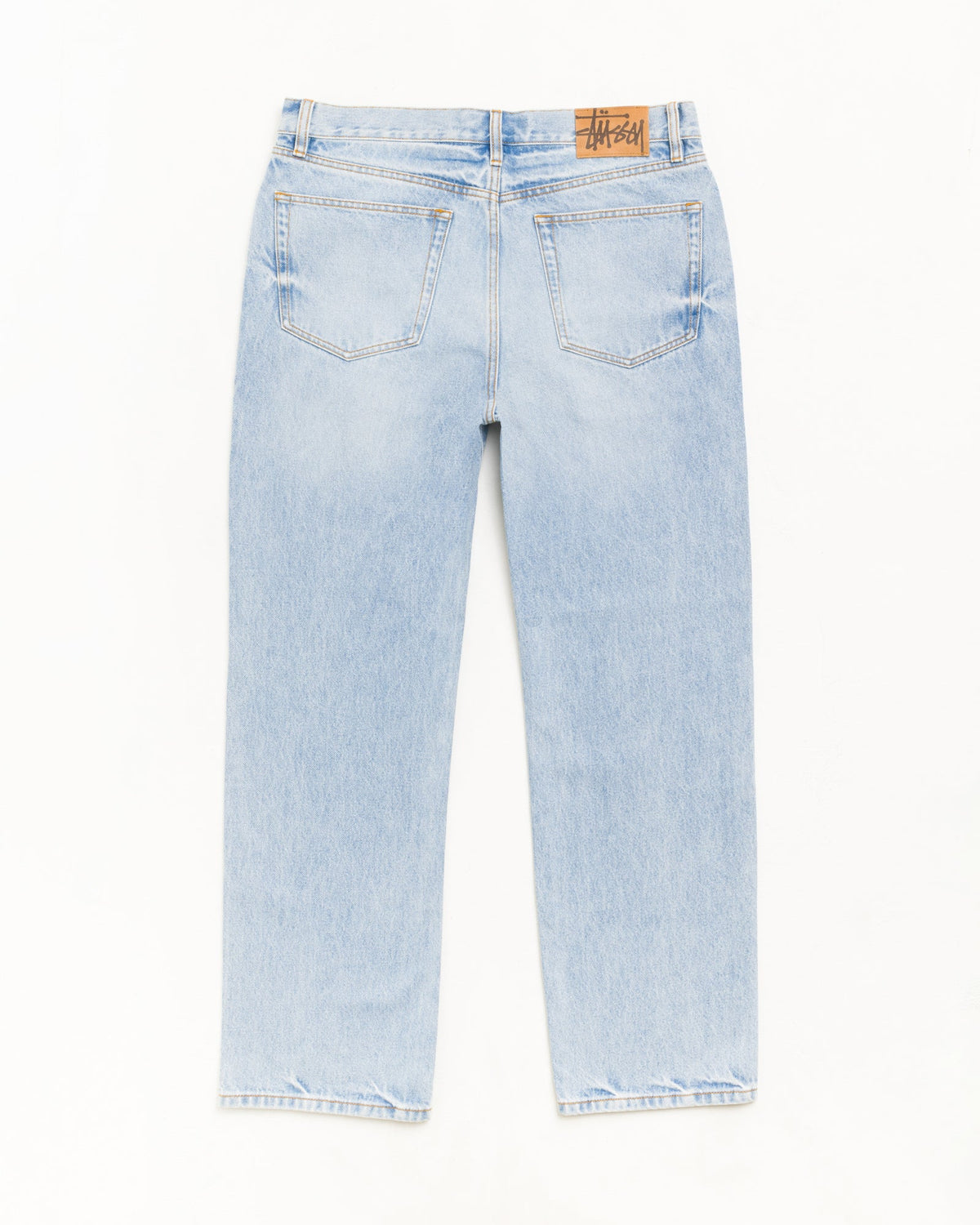 Light wash blue denim jeans shown from the back, featuring a brown leather brand patch on the back waistband, photographed against a plain white background.