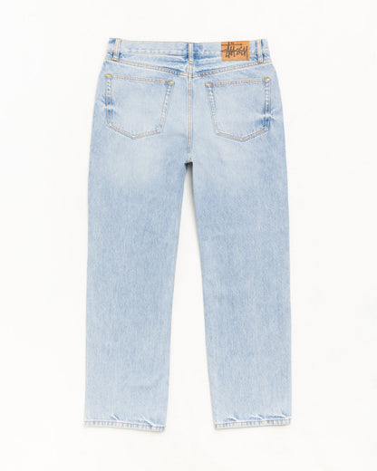 Light wash blue denim jeans shown from the back, featuring a brown leather brand patch on the back waistband, photographed against a plain white background.