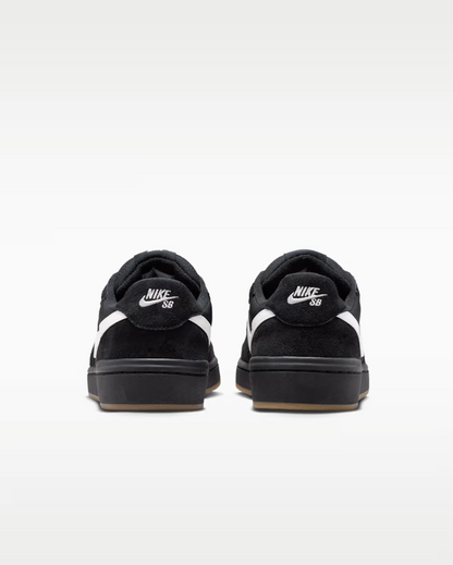A pair of black Nike SB low-top sneakers shown from the back, featuring white swooshes and white 'Nike SB' branding on the heel, set against a clean white background.